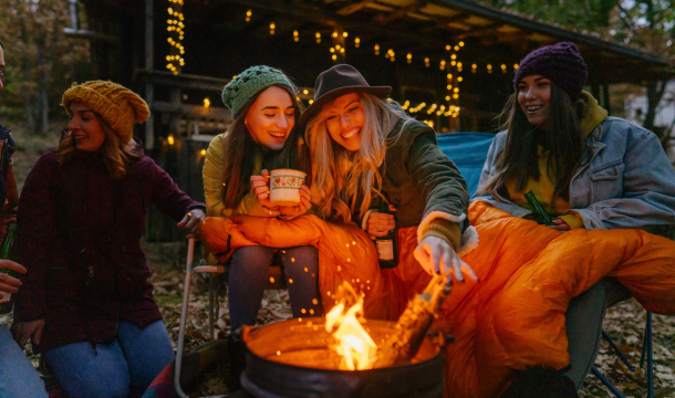 friends sitting around a campfire laughing