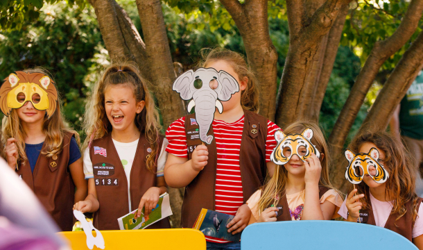 girl scouts posing with animal face props