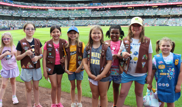 girl scouts standing in group at brewers game on field