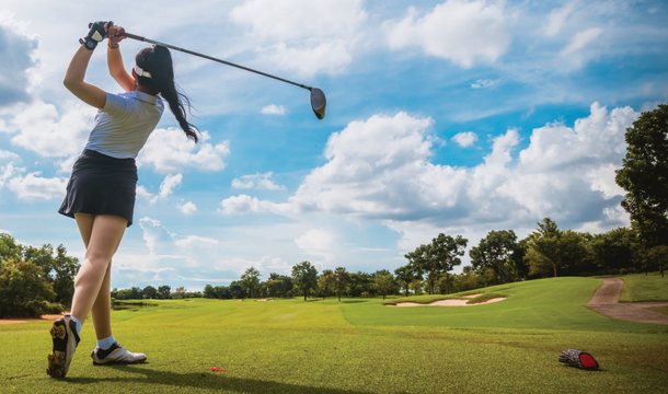 female golfer swinging club