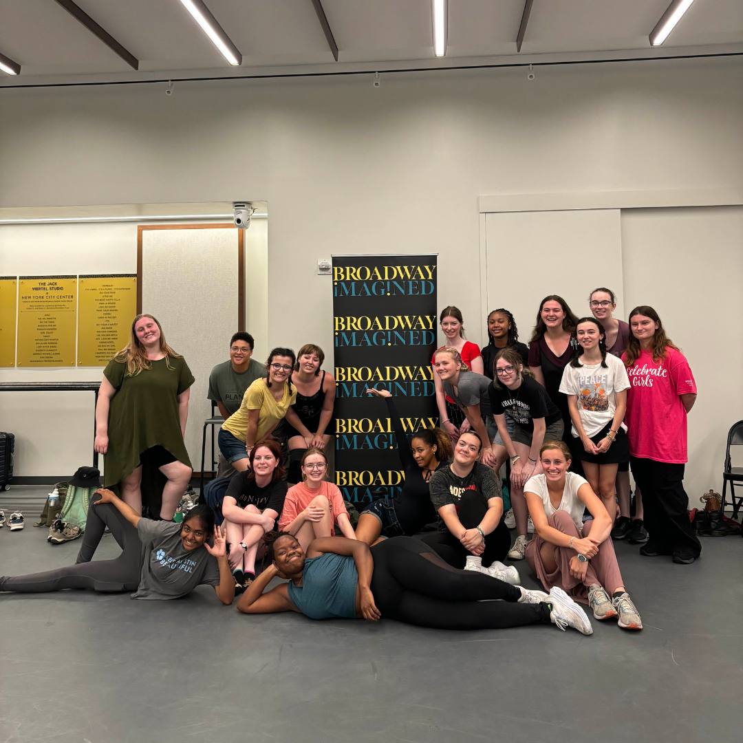 group of girl scouts posing with broadway sign