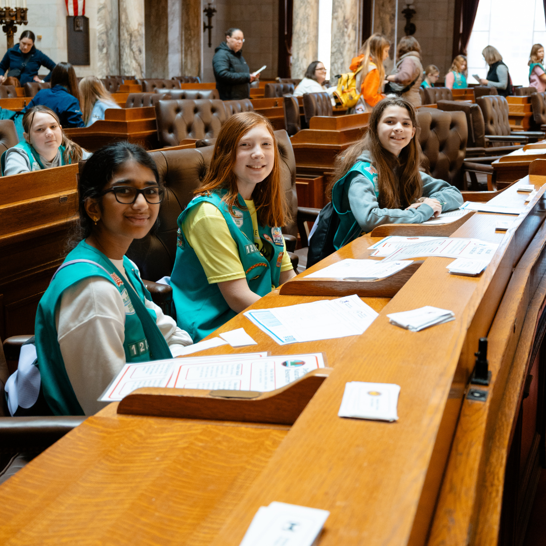 three girl scout juniors in state assembly seats