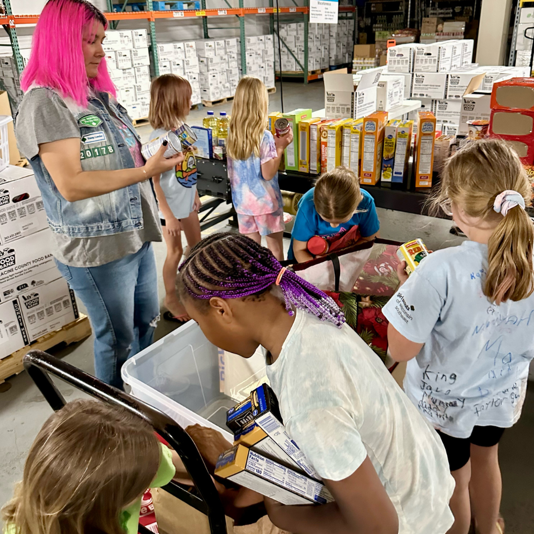 girl scout brownie troop volunteering at food bank
