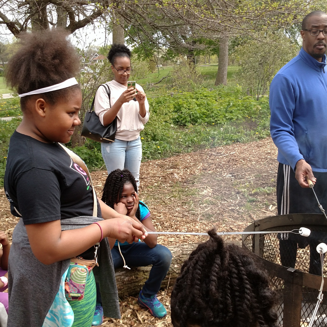 girl scout roasting marshmallow