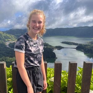 girl scout smiling in front of water