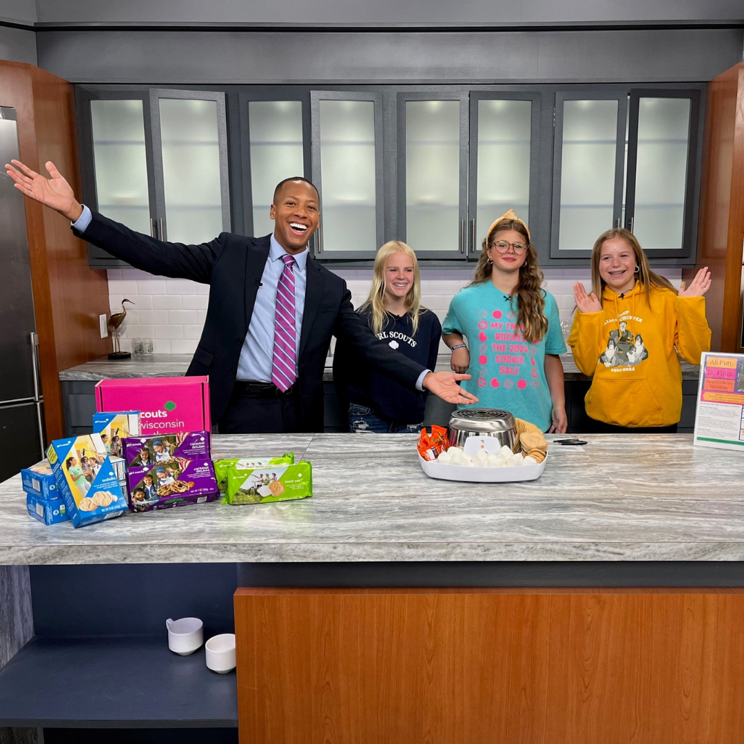 three girl scouts at tv station with anchor and smores