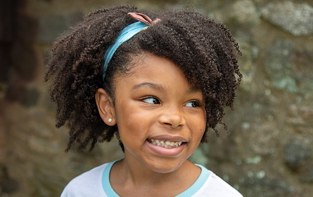 Young Girl Scout smiling and looking off to the left