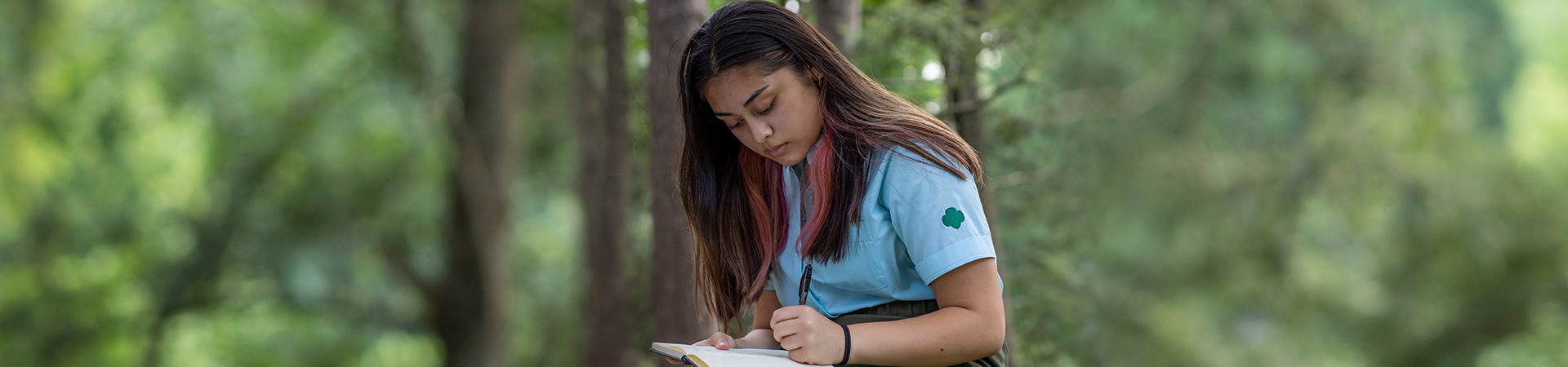  Older Girl Scout writing outdoors 