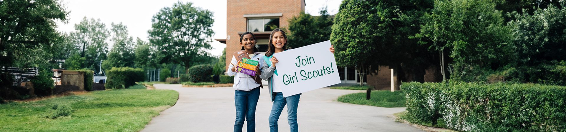  four Girl Scouts laughing outside 
