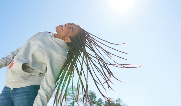 girl smiling with hair flipping back 