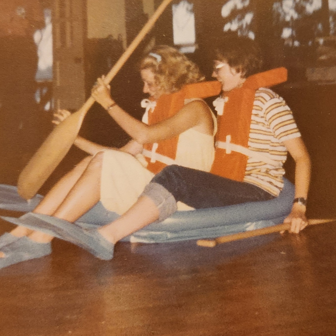two girl scouts on indoor raft with canoe paddle