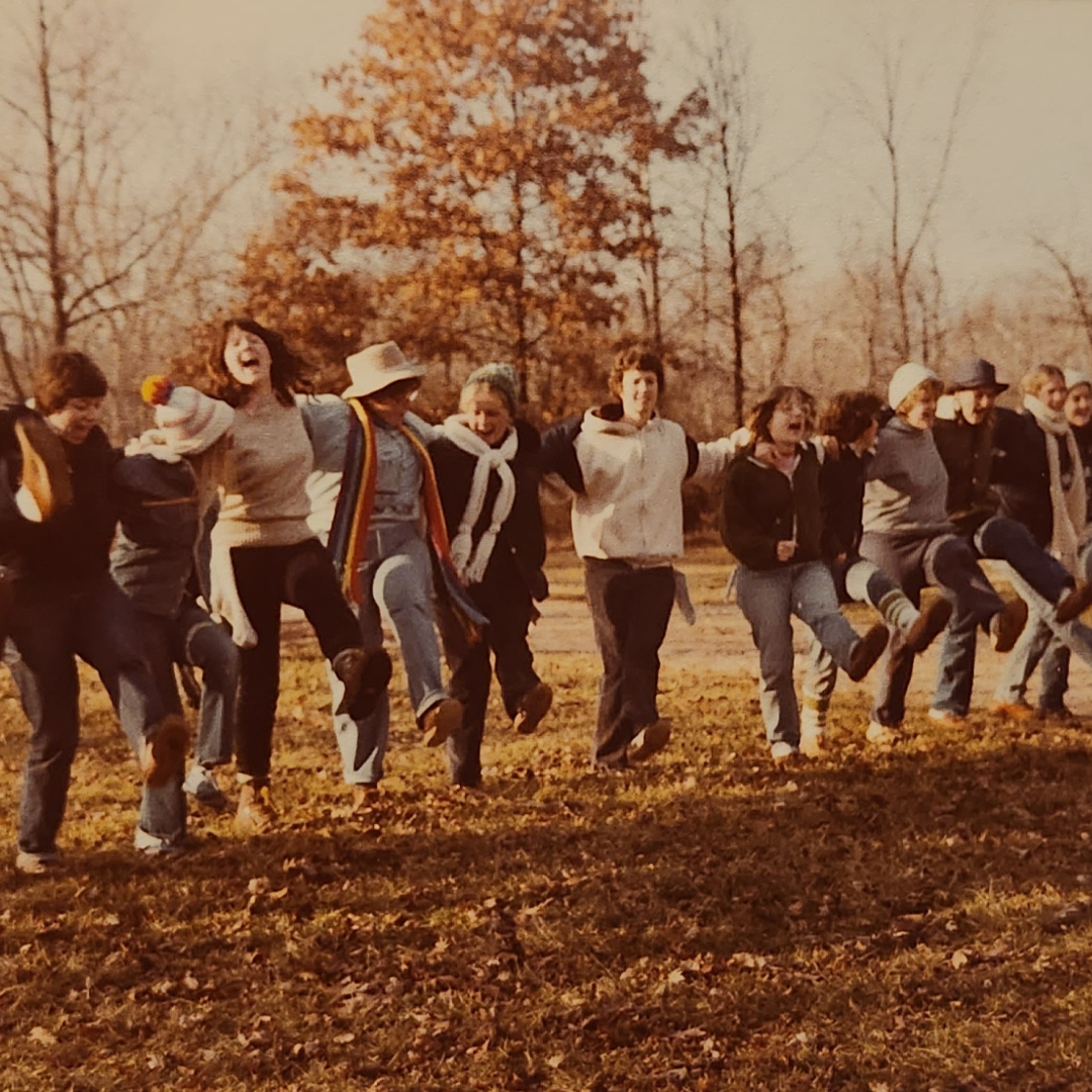 girl scouts in line outside kicking and laughing