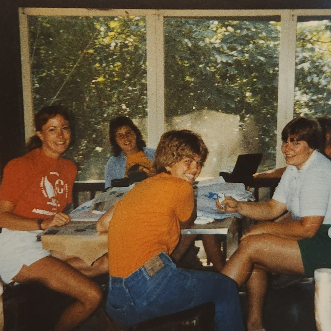 four camp counselors around table