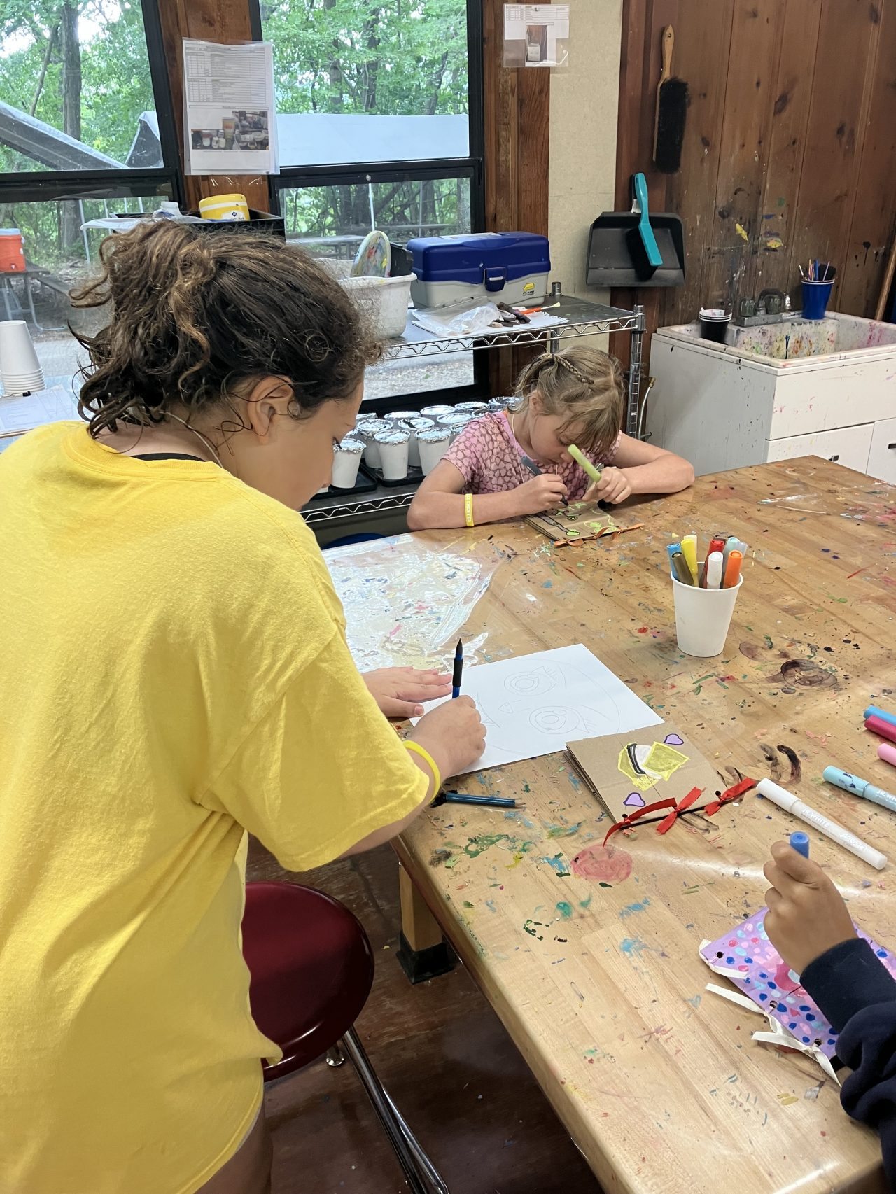 two girl scouts working on arts and crafts