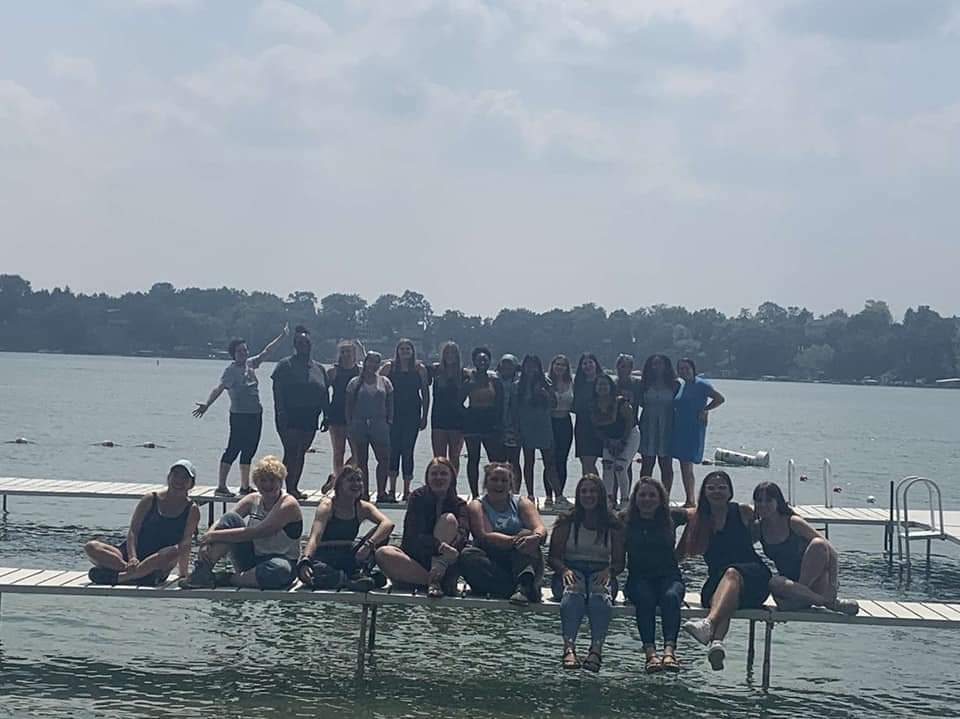 camp counselors on lake pier