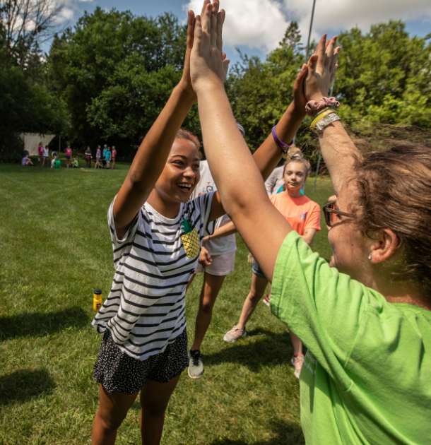 two girl scouts playing on sports and games field