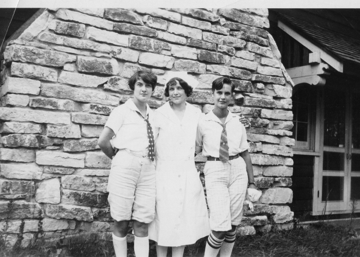 vintage black and white photo of campers outside building