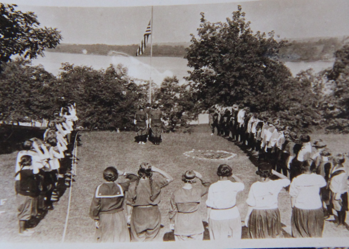 vintage black and white photo of campers doing flag ceremony