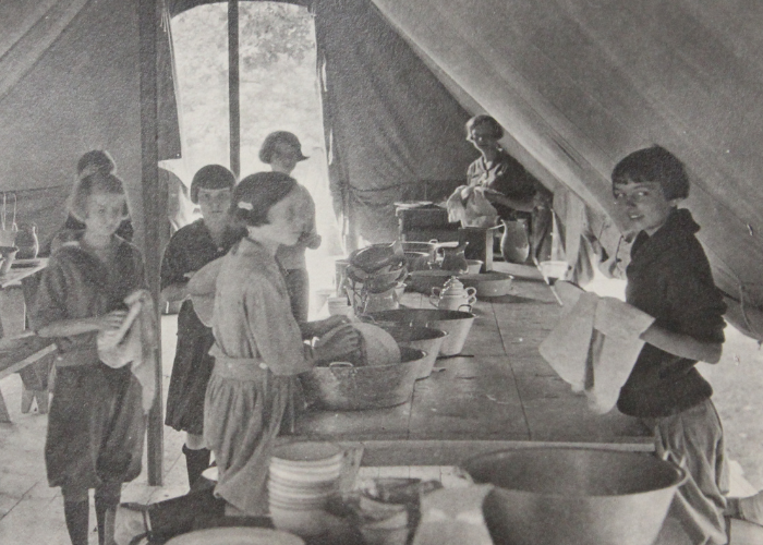 vintage black and white photo of campers cooking and washing dishes