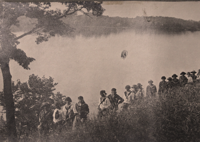 vintage black and white photo of campers hiking outdoors