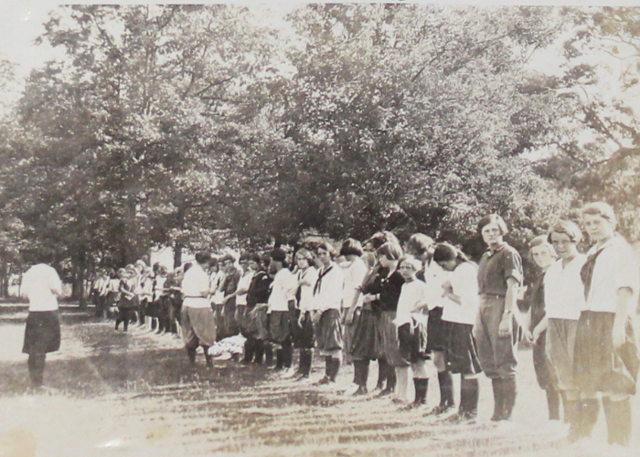 vintage black and white photo of campers lined up outside