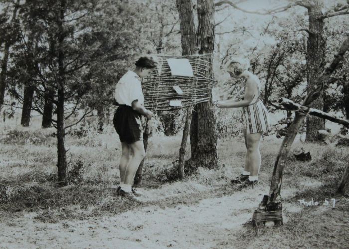 historic vintage black and white photo of two girl scouts at summer camp