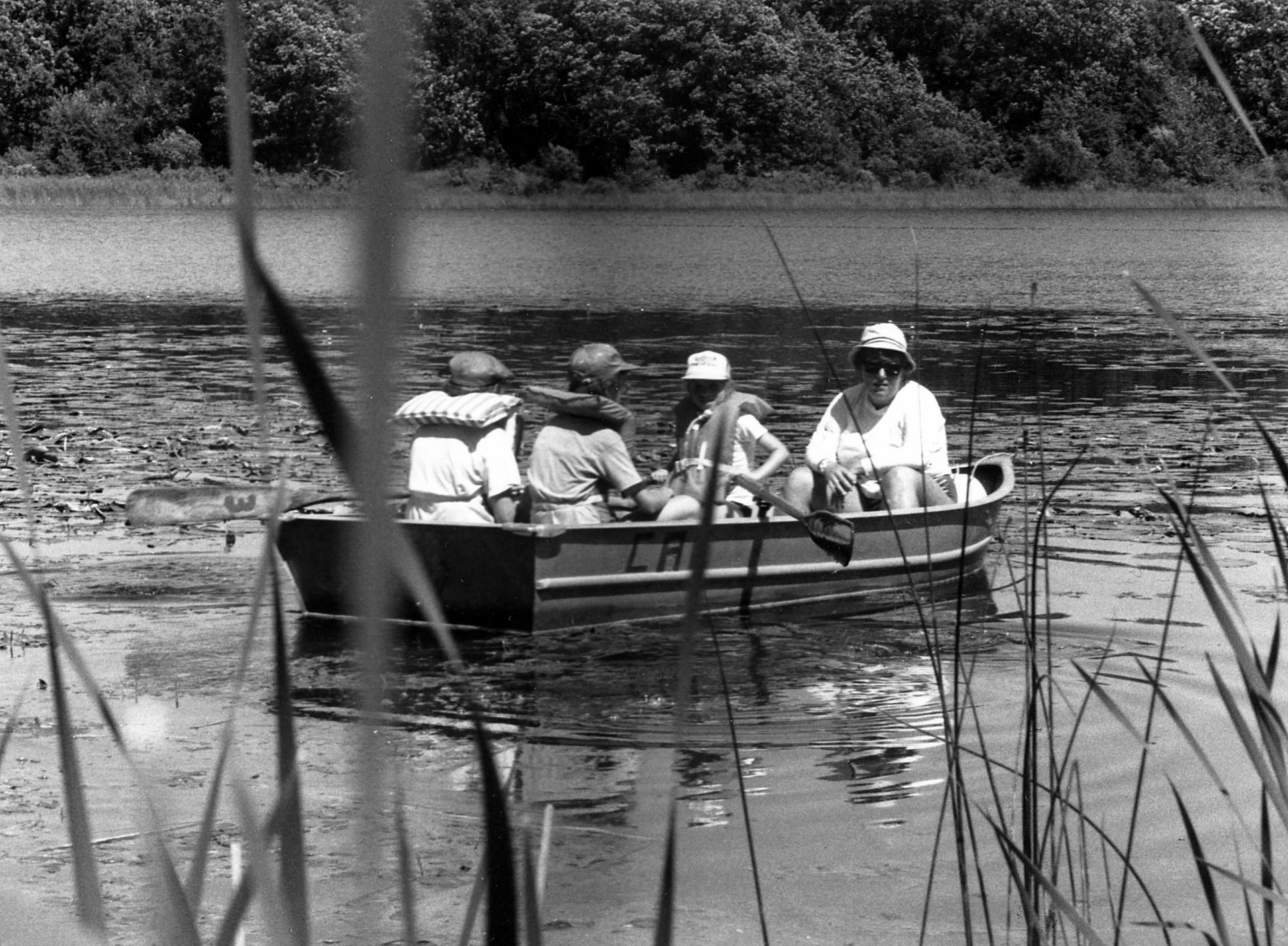 vintage black and white photo of girl scouts canoeing with adult