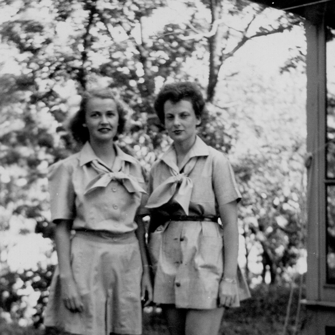 vintage black and white photo of two campers with arms around each other