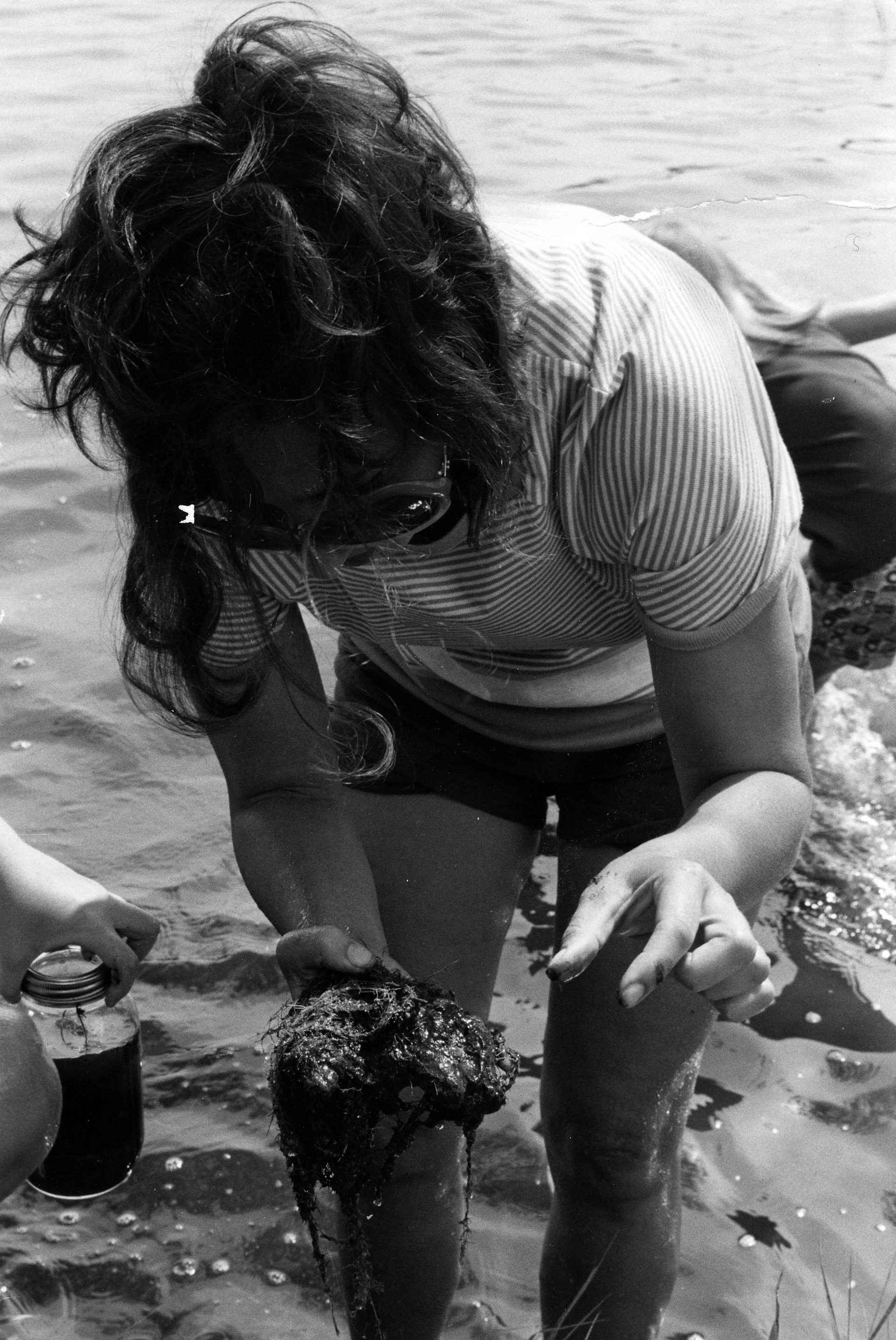 vintage black and white photo of camper exploring water