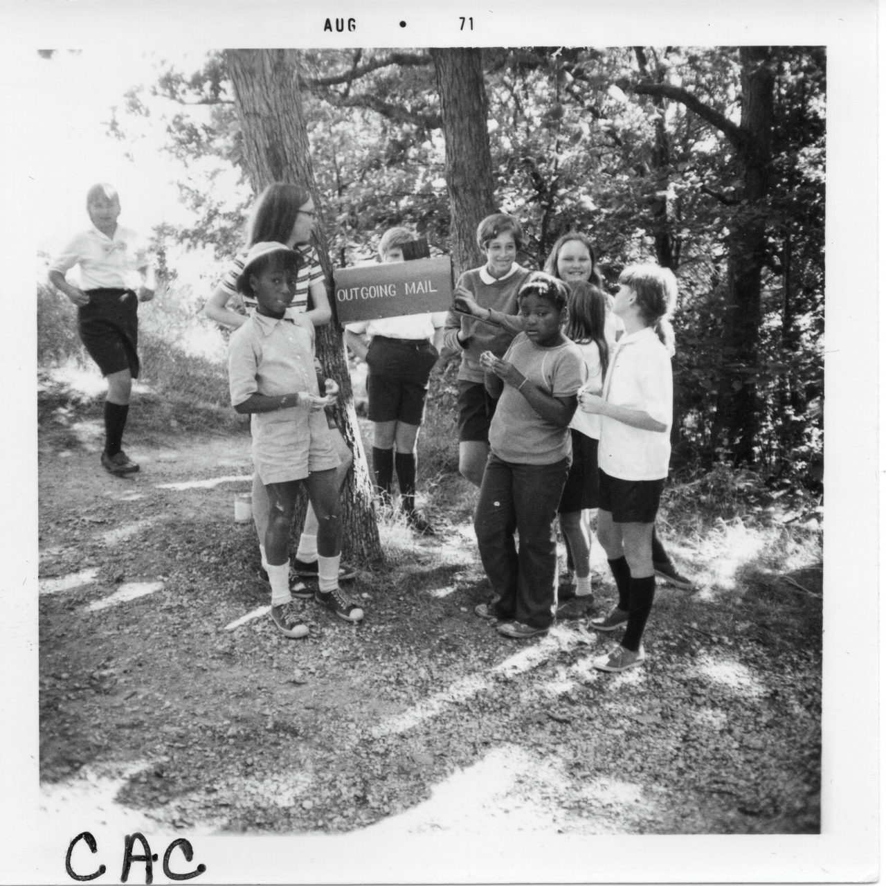historic vintage black and white photo of campers next to trail sign
