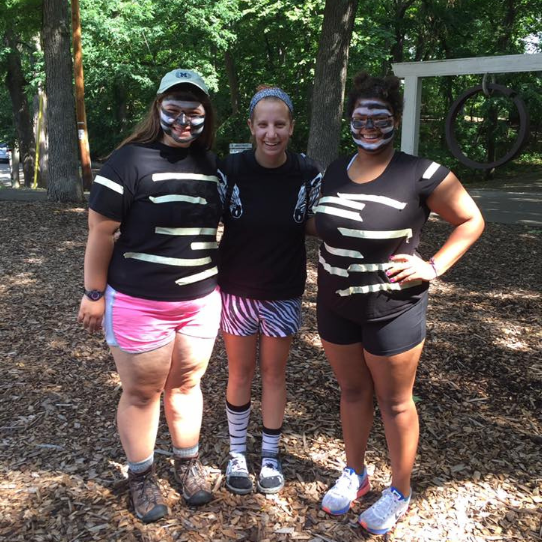 three campers dressed up in zebra print