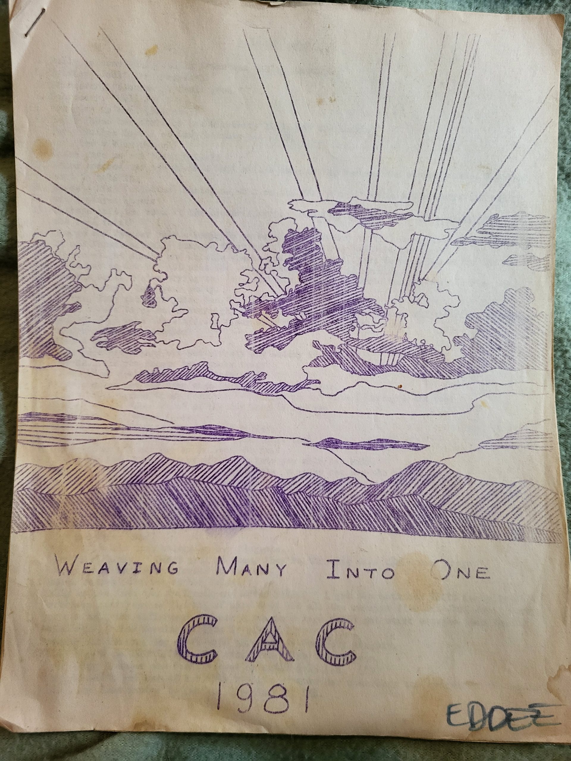 Hand drawn image of a sunrise over mountains with the words weaving many into one CAC 1981 underneath