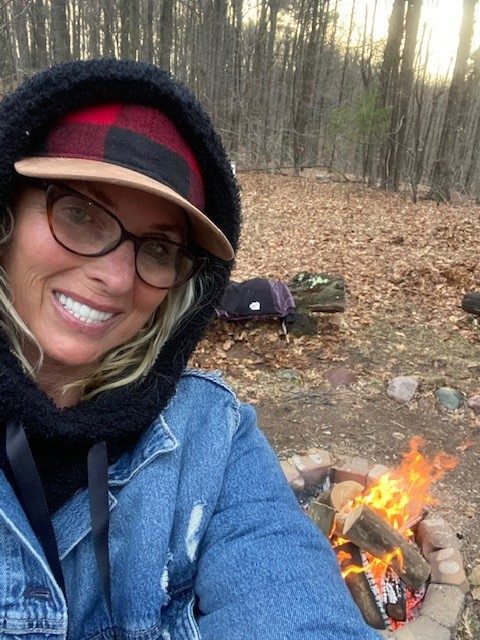 selfie of camp staff in front of fire