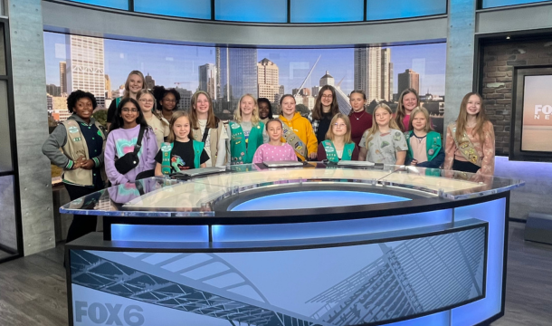 three girl scouts sitting at tv station