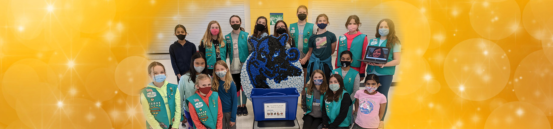  Group of Girl Scouts posing for photo with their recycled sculpture for their Bronze Award project 