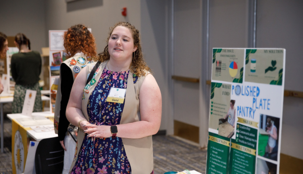 Gold Award Girl Scout explaining project at Highest Awards Celebration