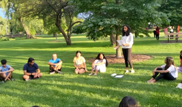 girl scout teaching group in outdoor park