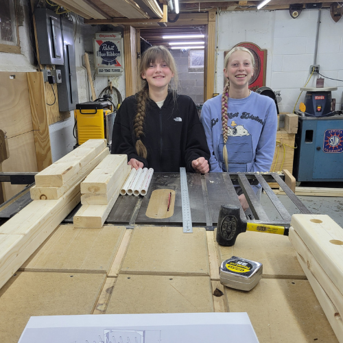 two girl scouts in woodworking shop