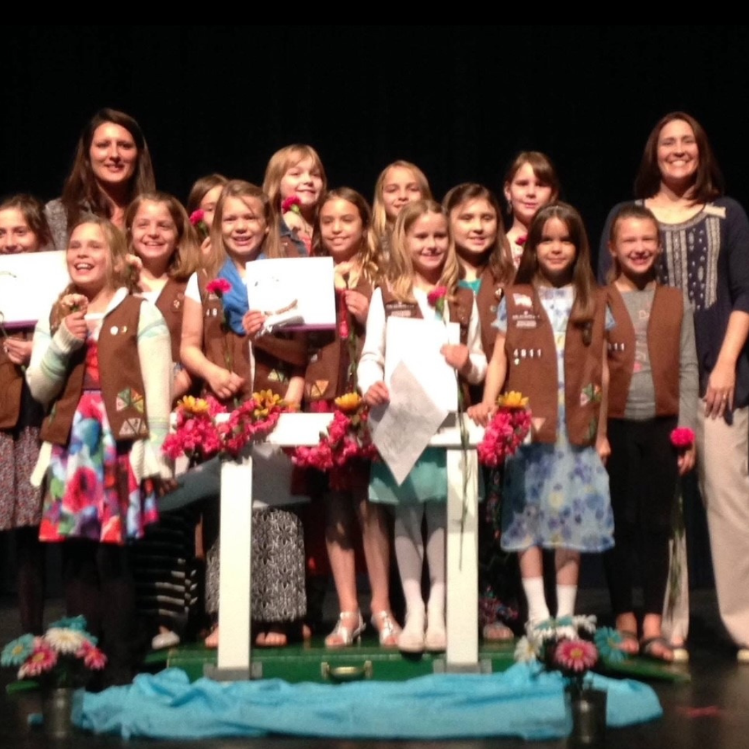 group of girl scout brownies in bridging ceremony