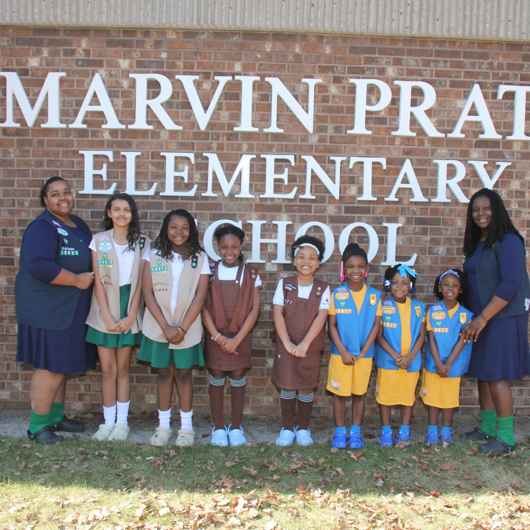 multilevel girl scout troop posing with troop leaders