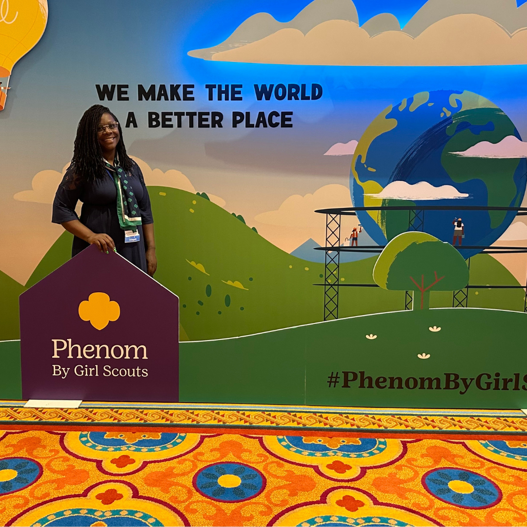 girl scout volunteer posing with national convention sign