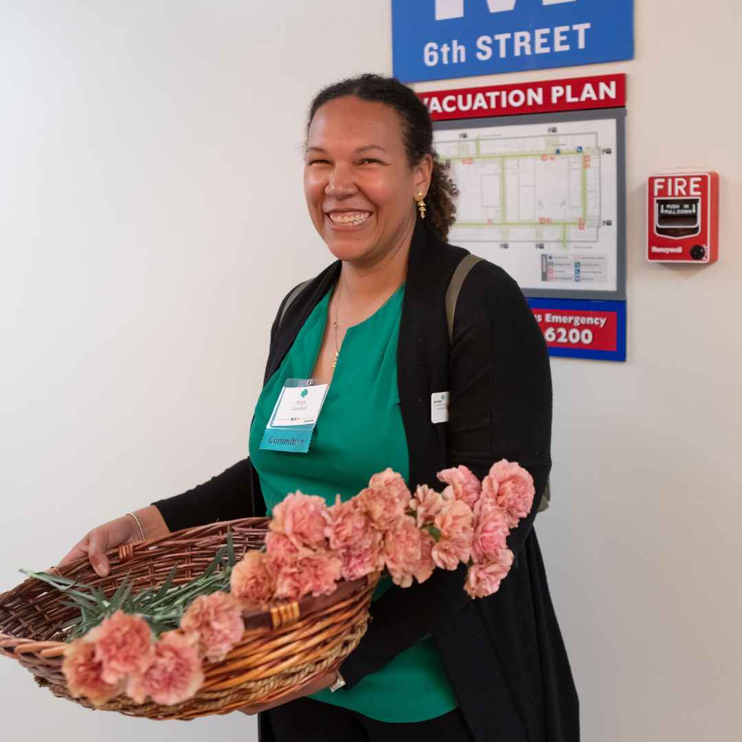 girl scout volunteer holding basket of flowers