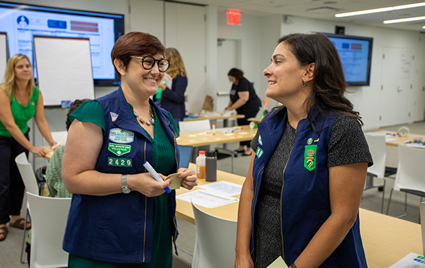 Two Girl Scout alum talking and smiling